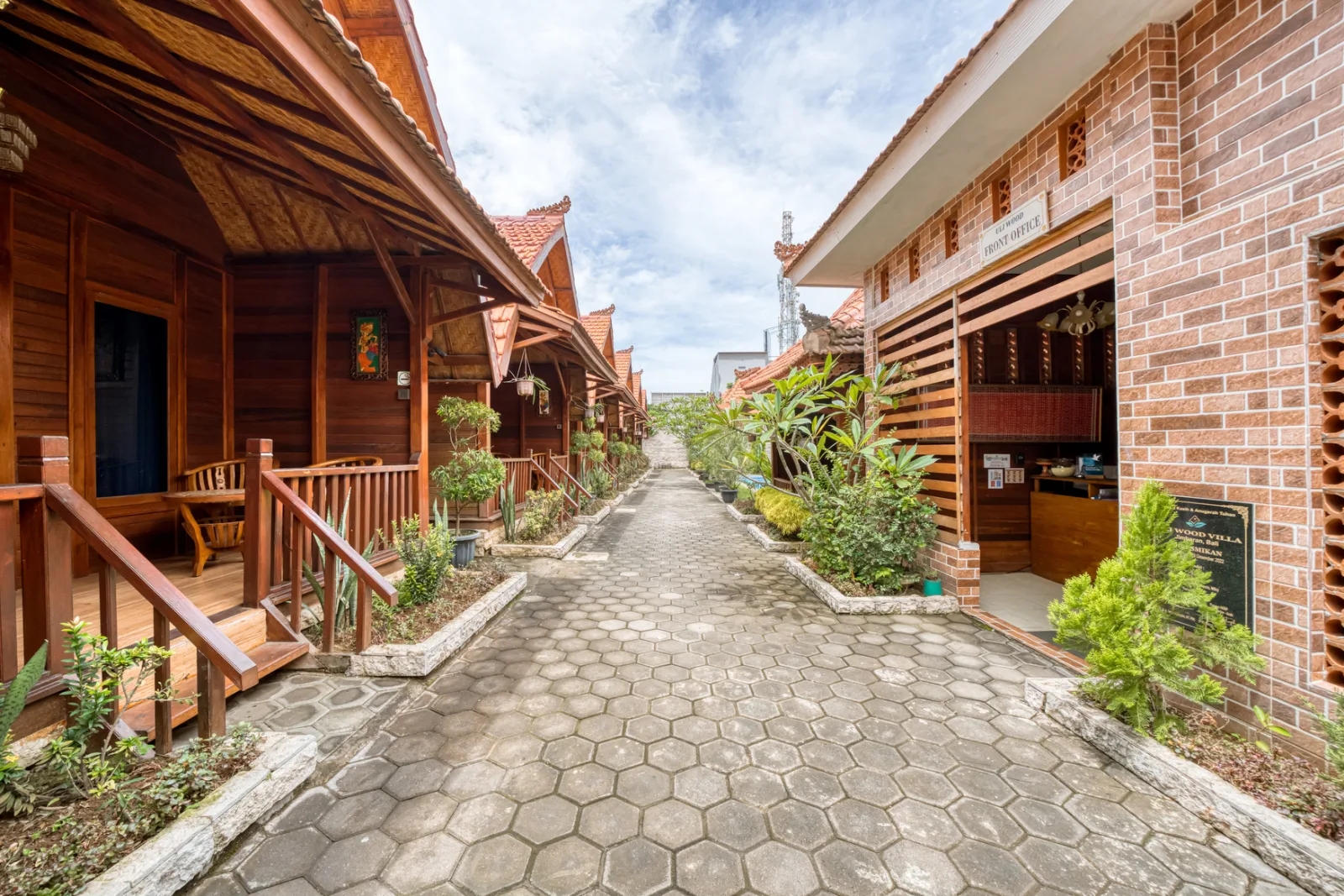 Uli Wood Villa Jimbaran wooden cabins and front office along the garden walkway